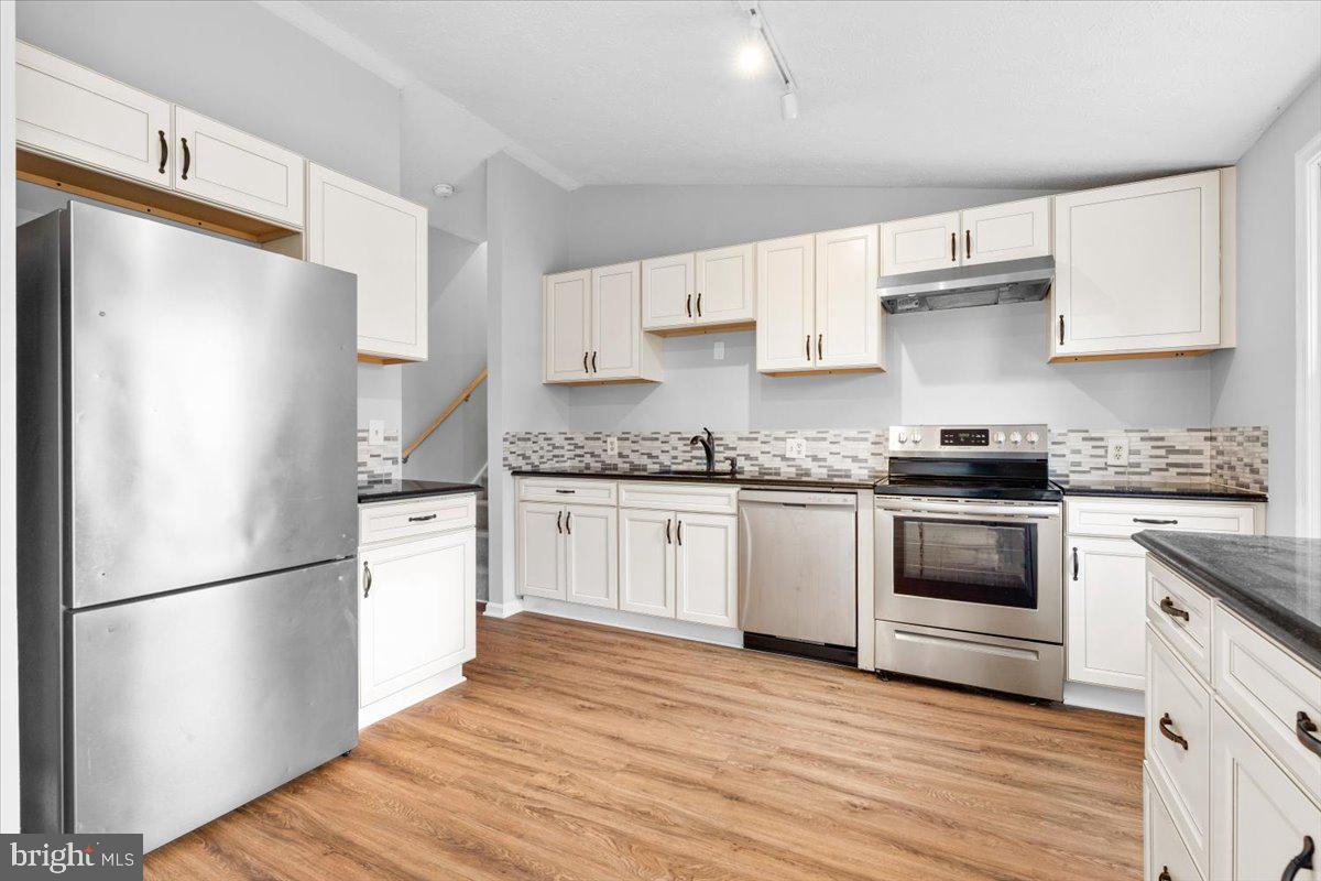 1489 Eden Drive Frederick, MD 21701 - Photo 12 of 43 a kitchen with granite countertop white cabinets and white appliances