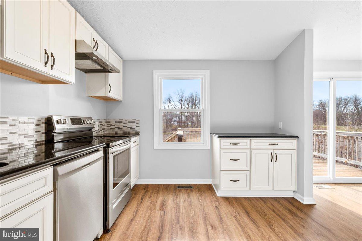 1489 Eden Drive Frederick, MD 21701 - Photo 13 of 43 a kitchen with stainless steel appliances granite countertop a stove and a white cabinets