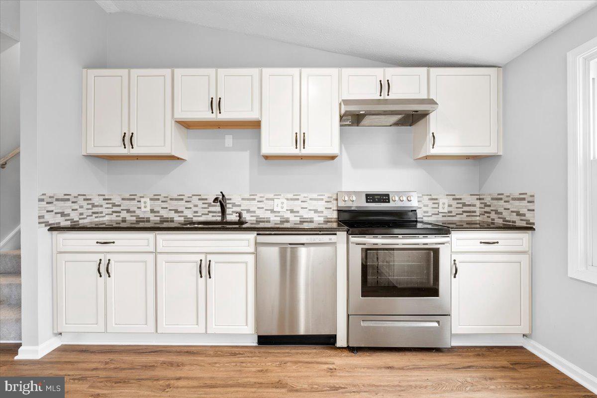 1489 Eden Drive Frederick, MD 21701 - Photo 15 of 43 a kitchen with granite countertop white cabinets and stainless steel appliances