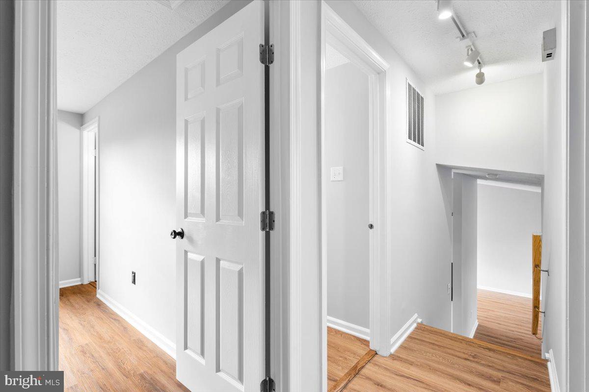 1489 Eden Drive Frederick, MD 21701 - Photo 16 of 43 a view of a hallway with wooden floor and staircase