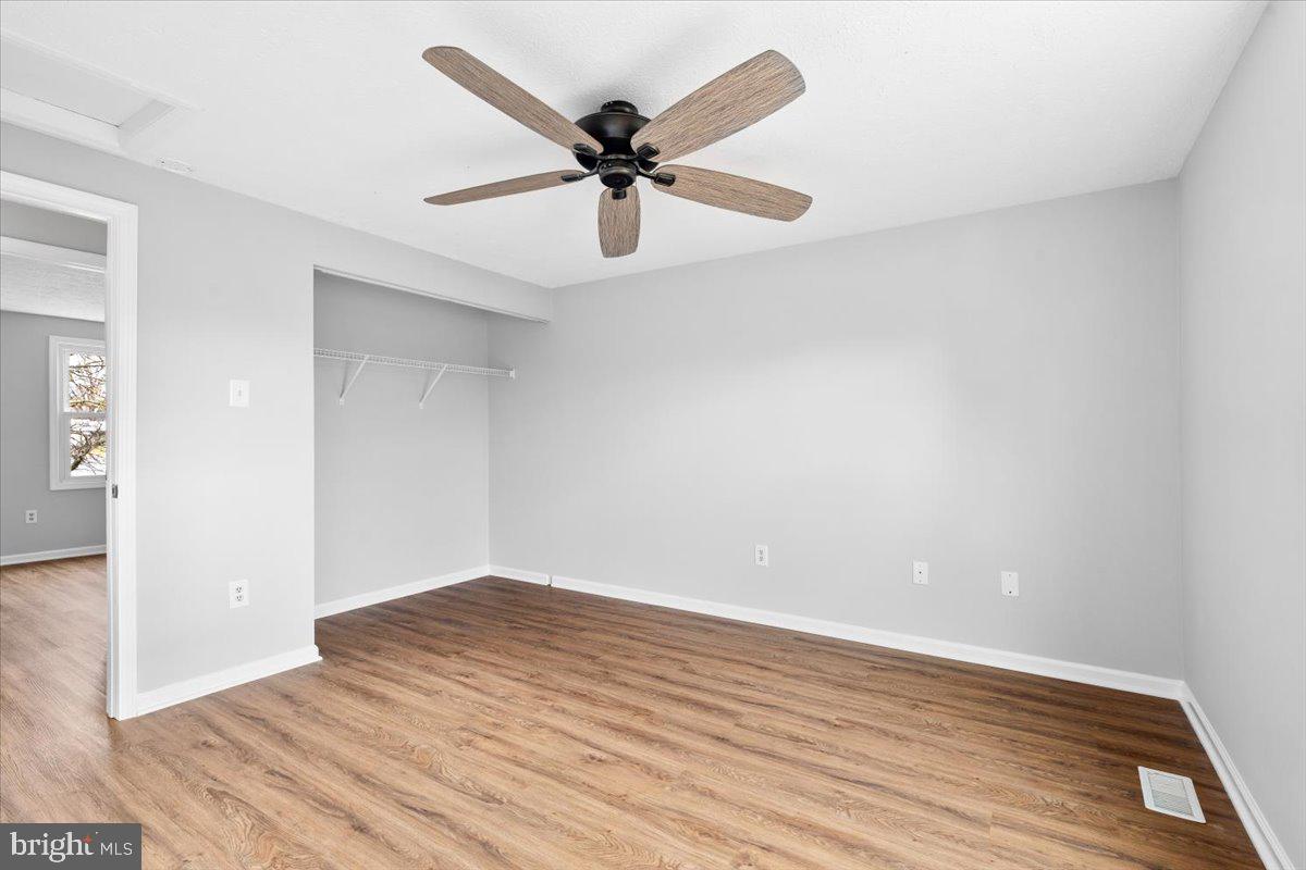 1489 Eden Drive Frederick, MD 21701 - Photo 19 of 43 an empty room with wooden floor fan and windows