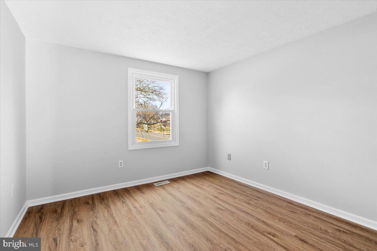 1489 Eden Drive Frederick, MD 21701 - Photo 21 of 43 an empty room with wooden floor and windows