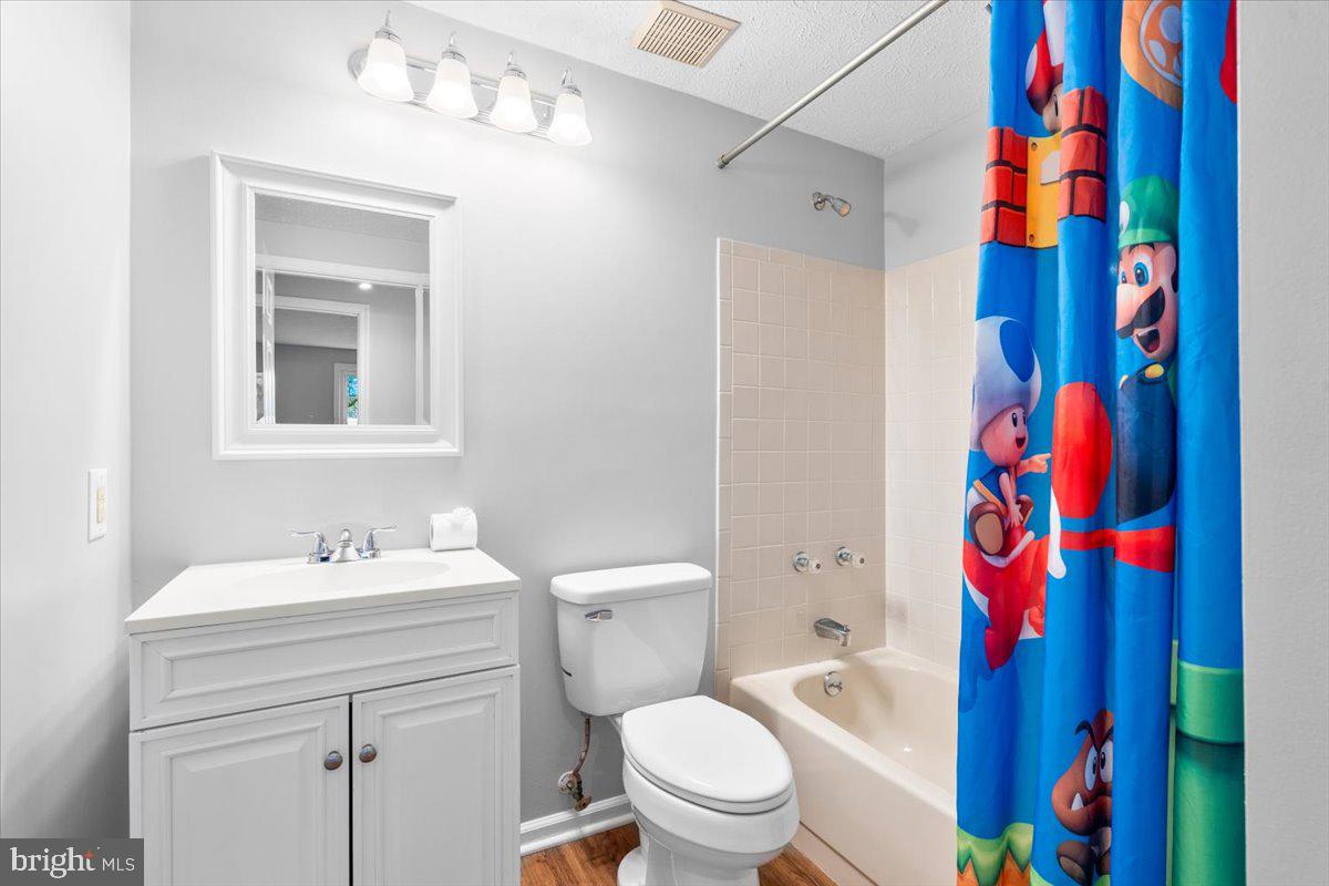 1489 Eden Drive Frederick, MD 21701 - Photo 23 of 43 a bathroom with a sink a toilet and shower curtain