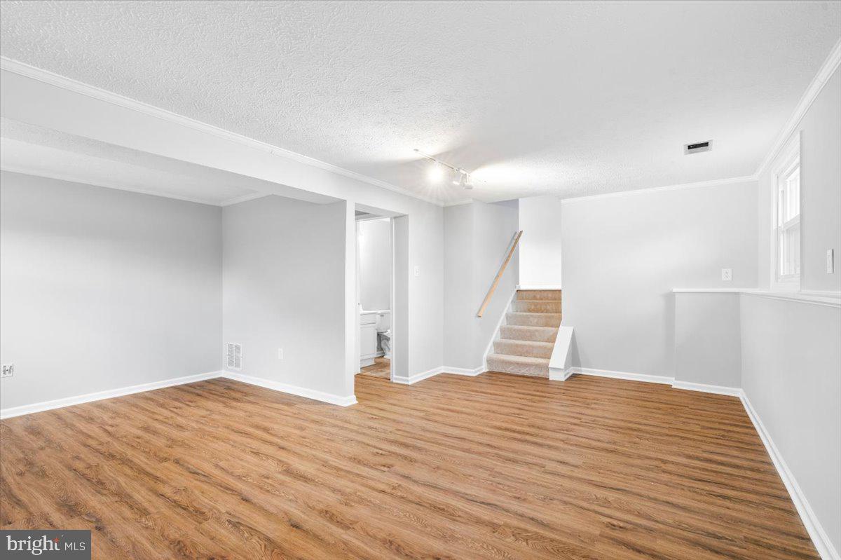 1489 Eden Drive Frederick, MD 21701 - Photo 26 of 43 a view of empty room with wooden floor