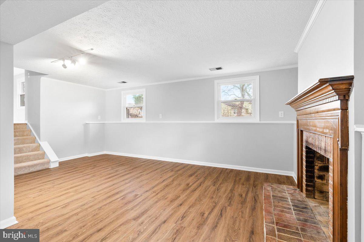 1489 Eden Drive Frederick, MD 21701 - Photo 27 of 43 an empty room with wooden floor and a fireplace