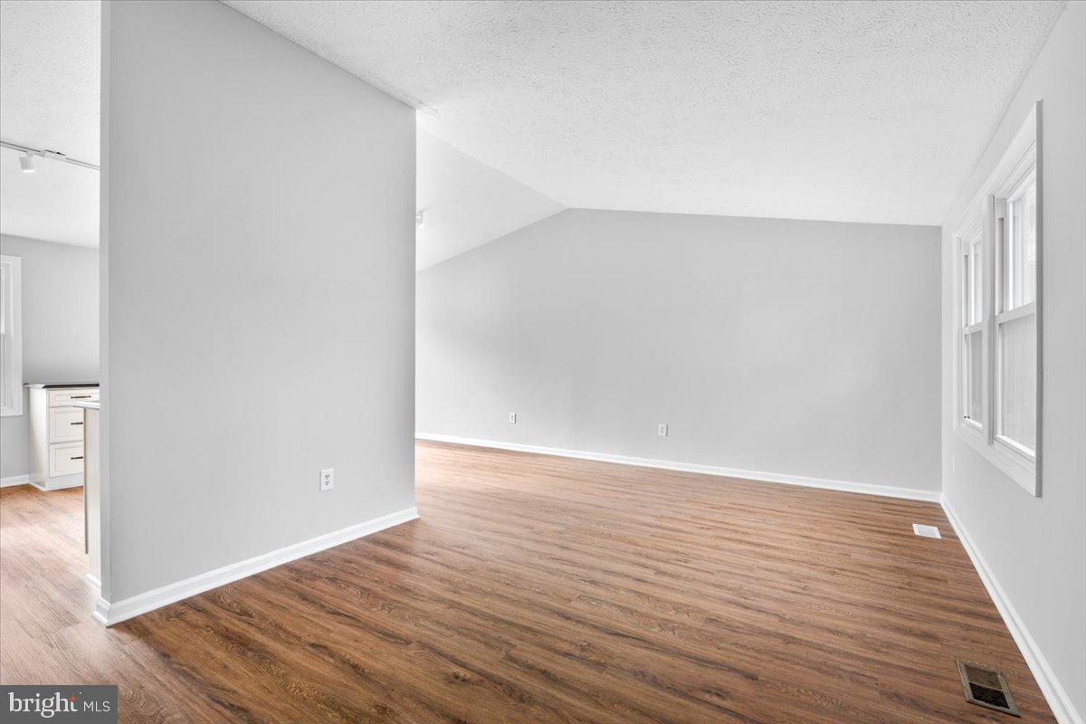 1489 Eden Drive Frederick, MD 21701 - Photo 5 of 43 wooden floor in a hall with an empty room