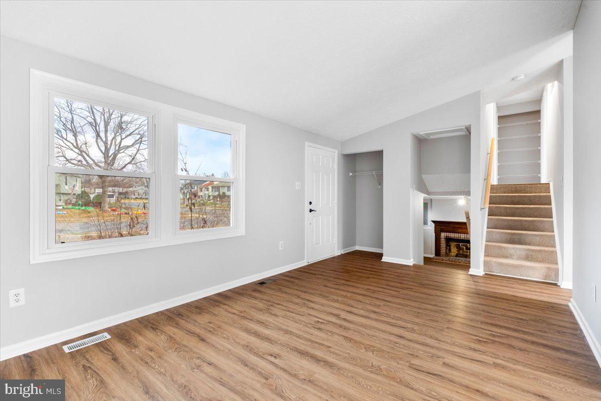 1489 Eden Drive Frederick, MD 21701 - Photo 6 of 43 a view of empty room with wooden floor and fireplace
