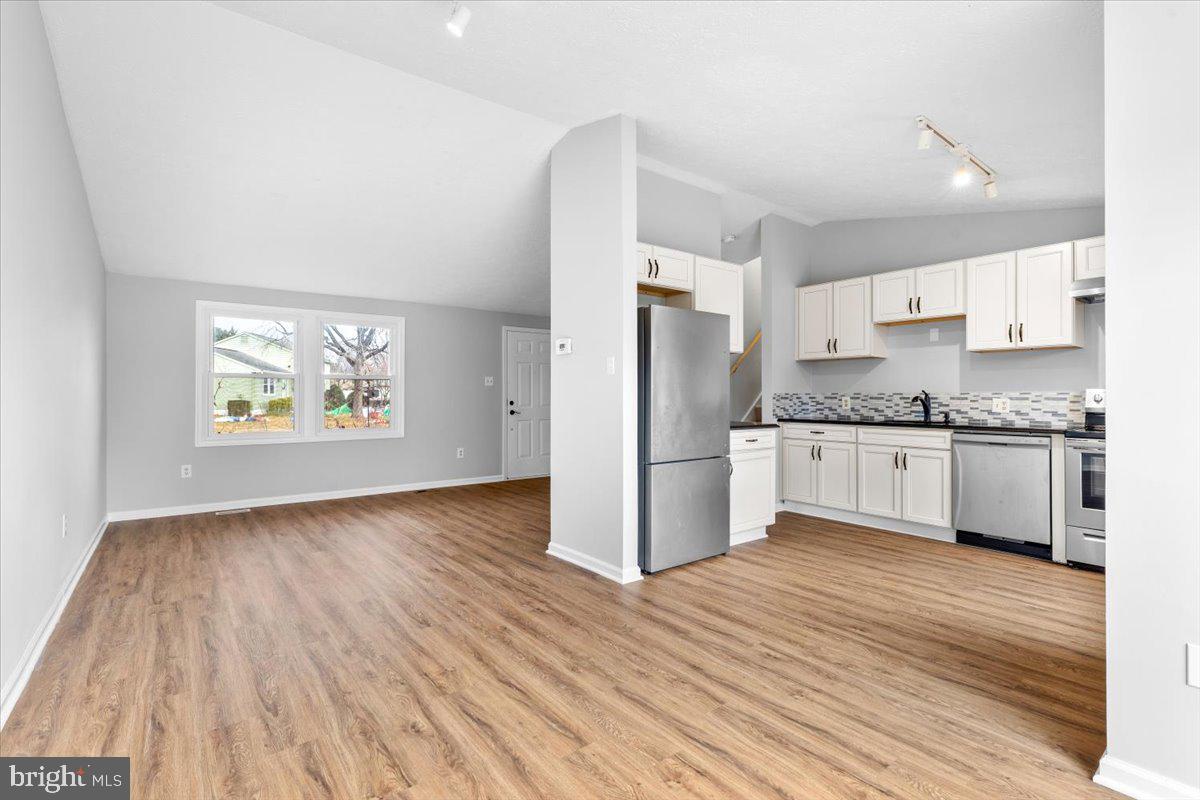 1489 Eden Drive Frederick, MD 21701 - Photo 9 of 43 a kitchen with stainless steel appliances granite countertop a refrigerator and a stove top oven