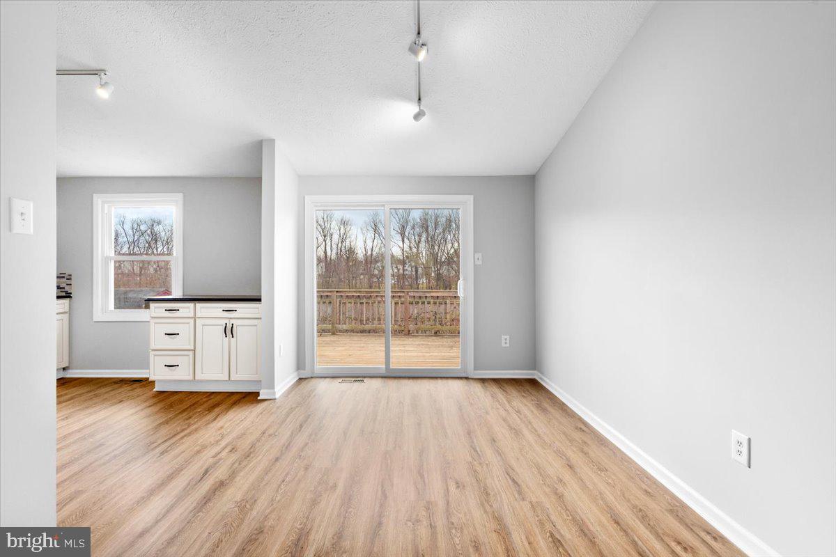 1489 Eden Drive Frederick, MD 21701 - Photo 10 of 43 a view of an empty room with a window and wooden floor