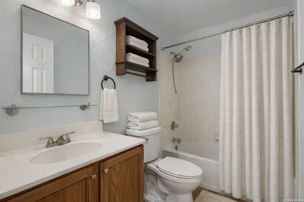 a bathroom with a sink toilet tub and shower