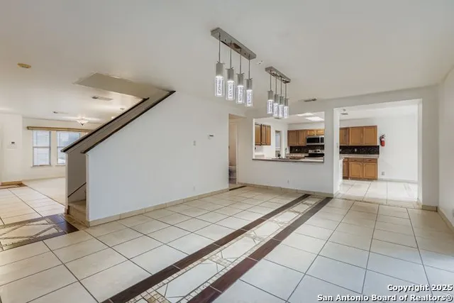 a view of kitchen with refrigerator and microwave