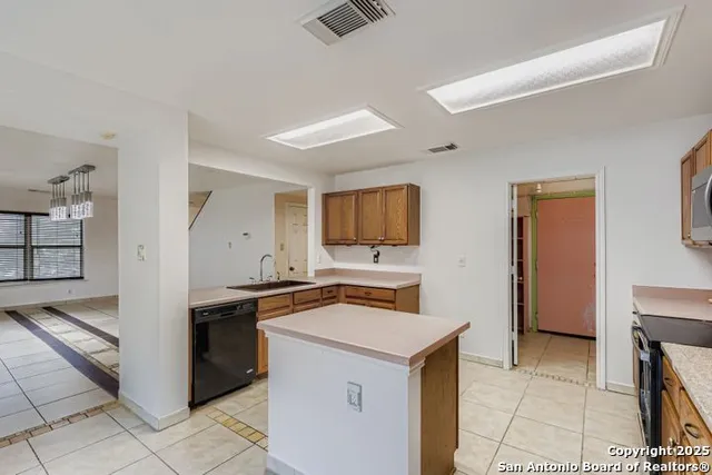 a kitchen with a stove sink and a refrigerator