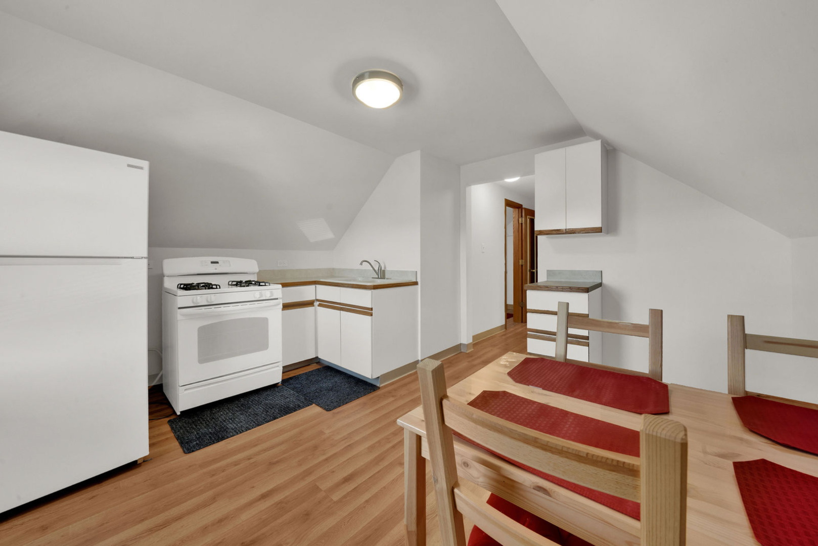 6238 South Massasoit Avenue, Unit 2 Chicago, IL 60638 - Photo 3 of 7 a kitchen with white cabinets and white appliances