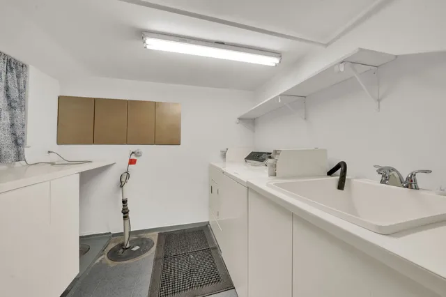 a kitchen with a sink and cabinets