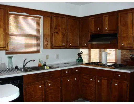 a kitchen with sink and cabinets