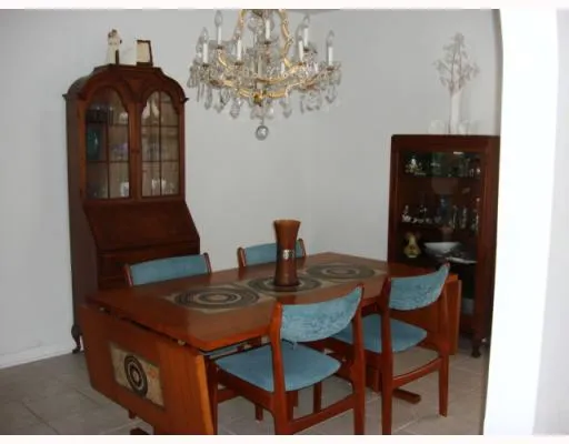 a dining room with furniture and chandelier