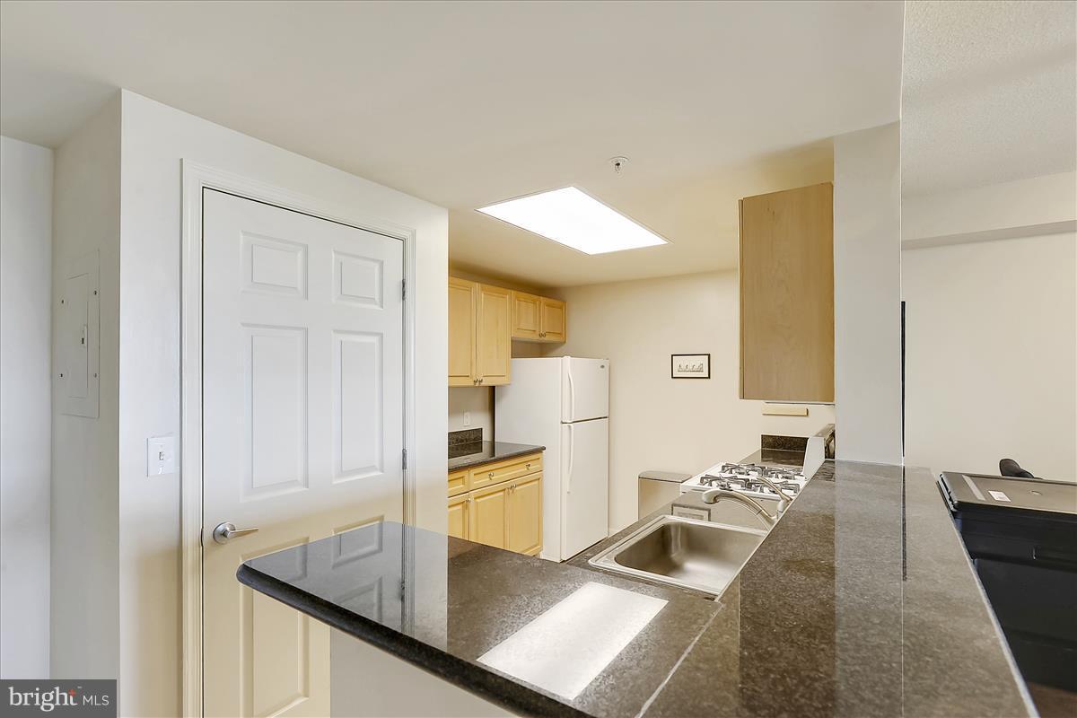 2726 Gallows Road, Unit 612 Vienna, VA 22180 - Photo 2 of 30 a kitchen with stainless steel appliances granite countertop a sink and a refrigerator