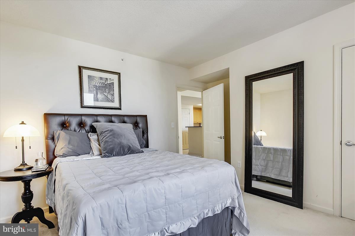2726 Gallows Road, Unit 612 Vienna, VA 22180 - Photo 11 of 30 a bedroom with a bed and a mirror