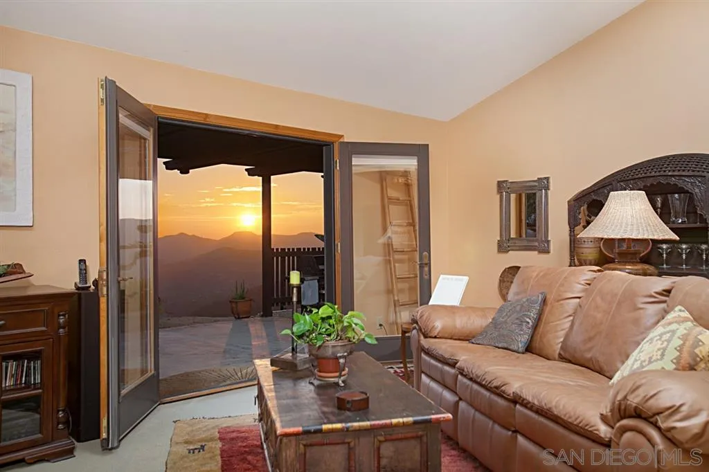 16987 Lyons Valley Road Jamul, CA 91935 - Photo 12 of 25 a living room with furniture and a floor to ceiling window