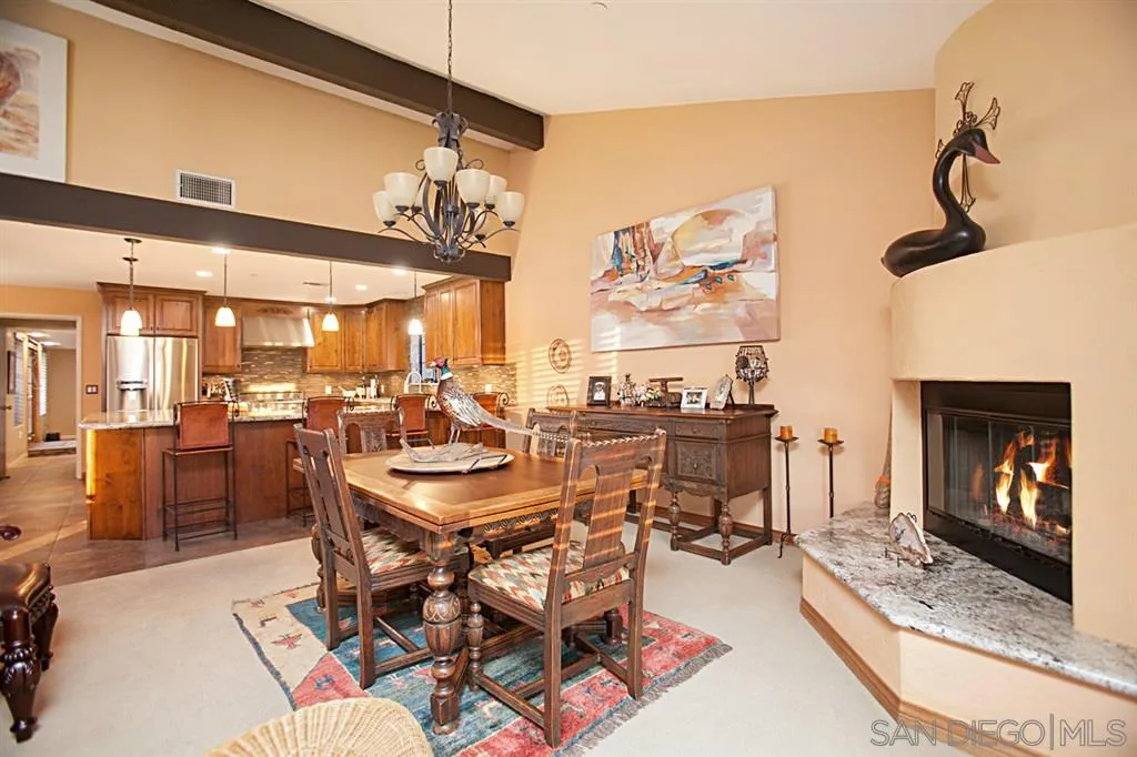 16987 Lyons Valley Road Jamul, CA 91935 - Photo 10 of 25 a dining hall with stainless steel appliances kitchen island granite countertop a table and chairs in it