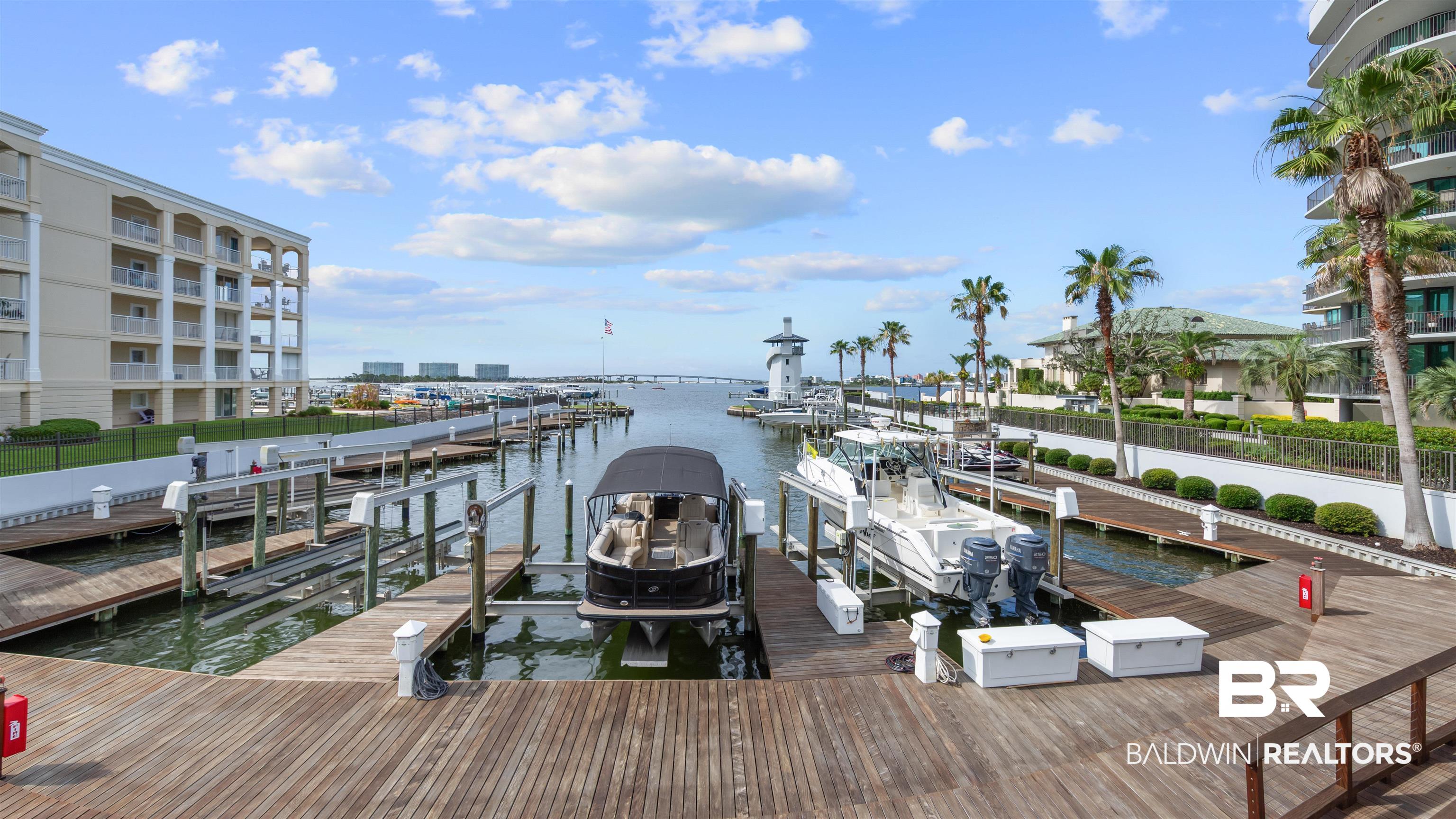 27582 Canal Road, Unit 2207 Orange Beach, AL 36561 - Photo 19 of 25 Dock featuring boat lift and a water view