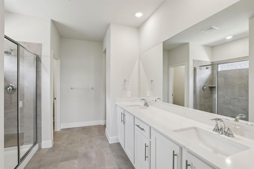 2206 Windy Trail Princeton, TX 75407 - Photo 29 of 34 a spacious bathroom with double vanity and mirrors