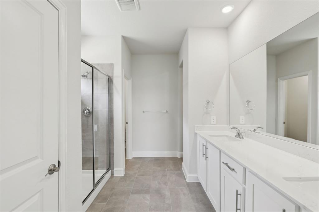 2206 Windy Trail Princeton, TX 75407 - Photo 30 of 34 a spacious bathroom with a double vanity sink and a mirror