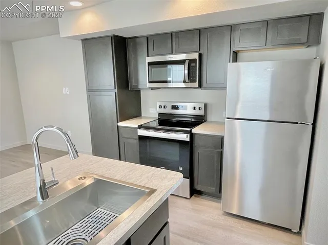 a kitchen with a refrigerator sink and microwave