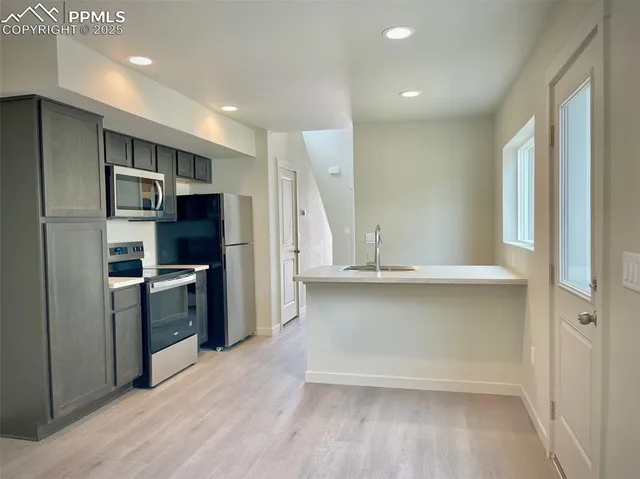 a kitchen with a refrigerator and a sink