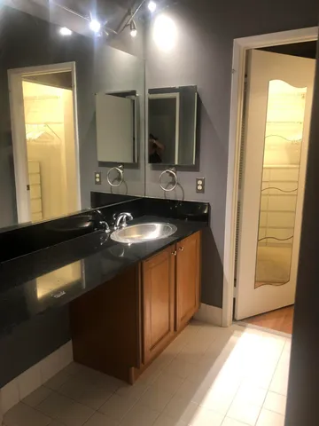 a kitchen with a sink and a mirror