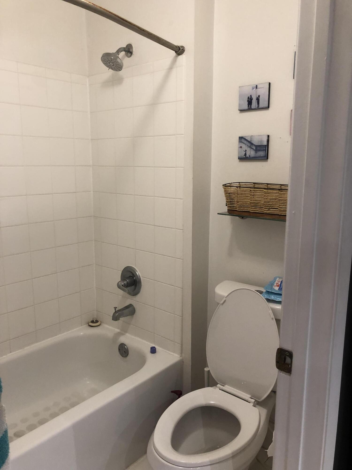 6936 Southwest 39th Street, Unit 304D Davie, FL 33314 - Photo 15 of 25 a bathroom with a toilet and a bathtub