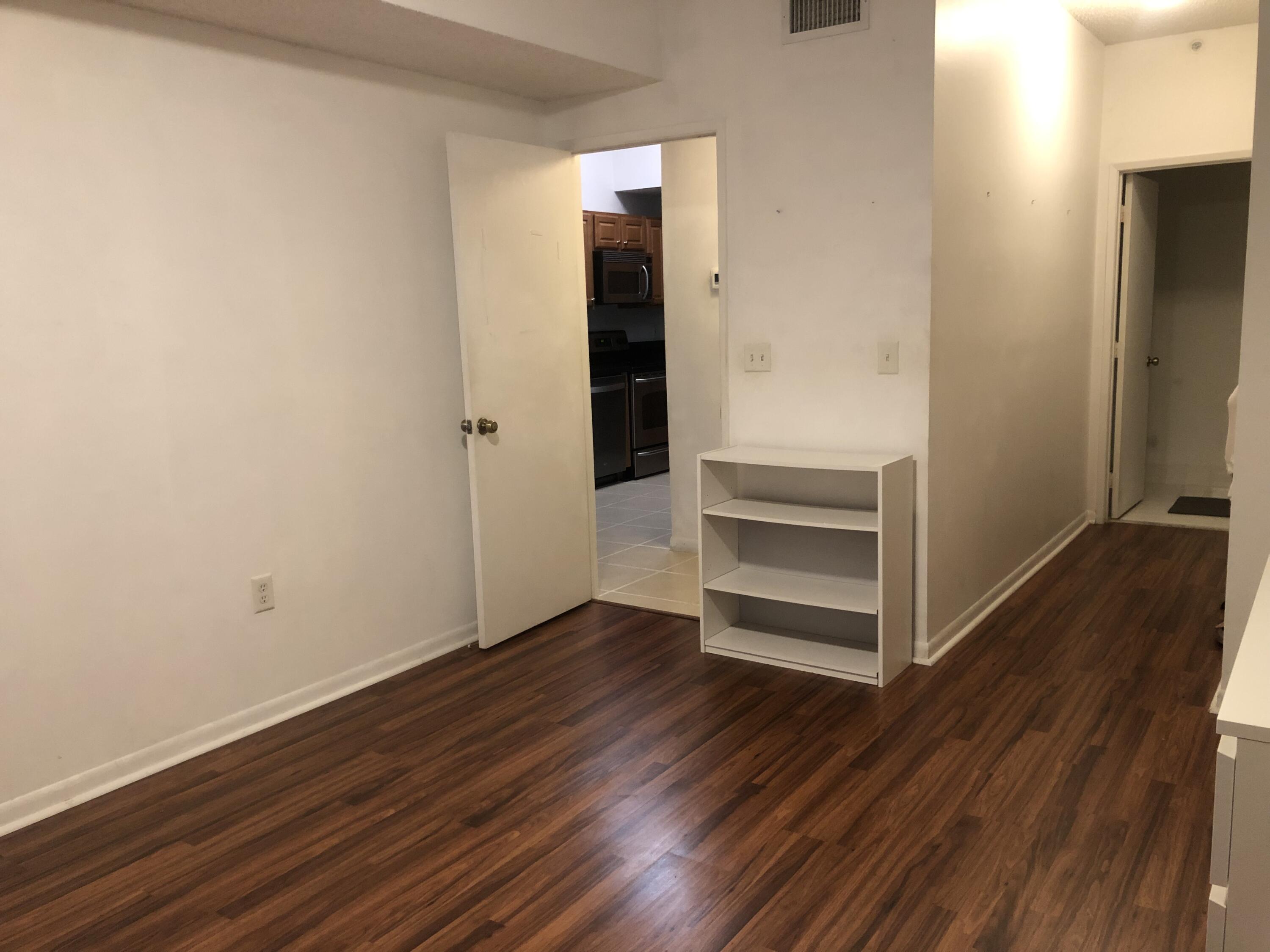 6936 Southwest 39th Street, Unit 304D Davie, FL 33314 - Photo 17 of 25 an empty room with wooden floor