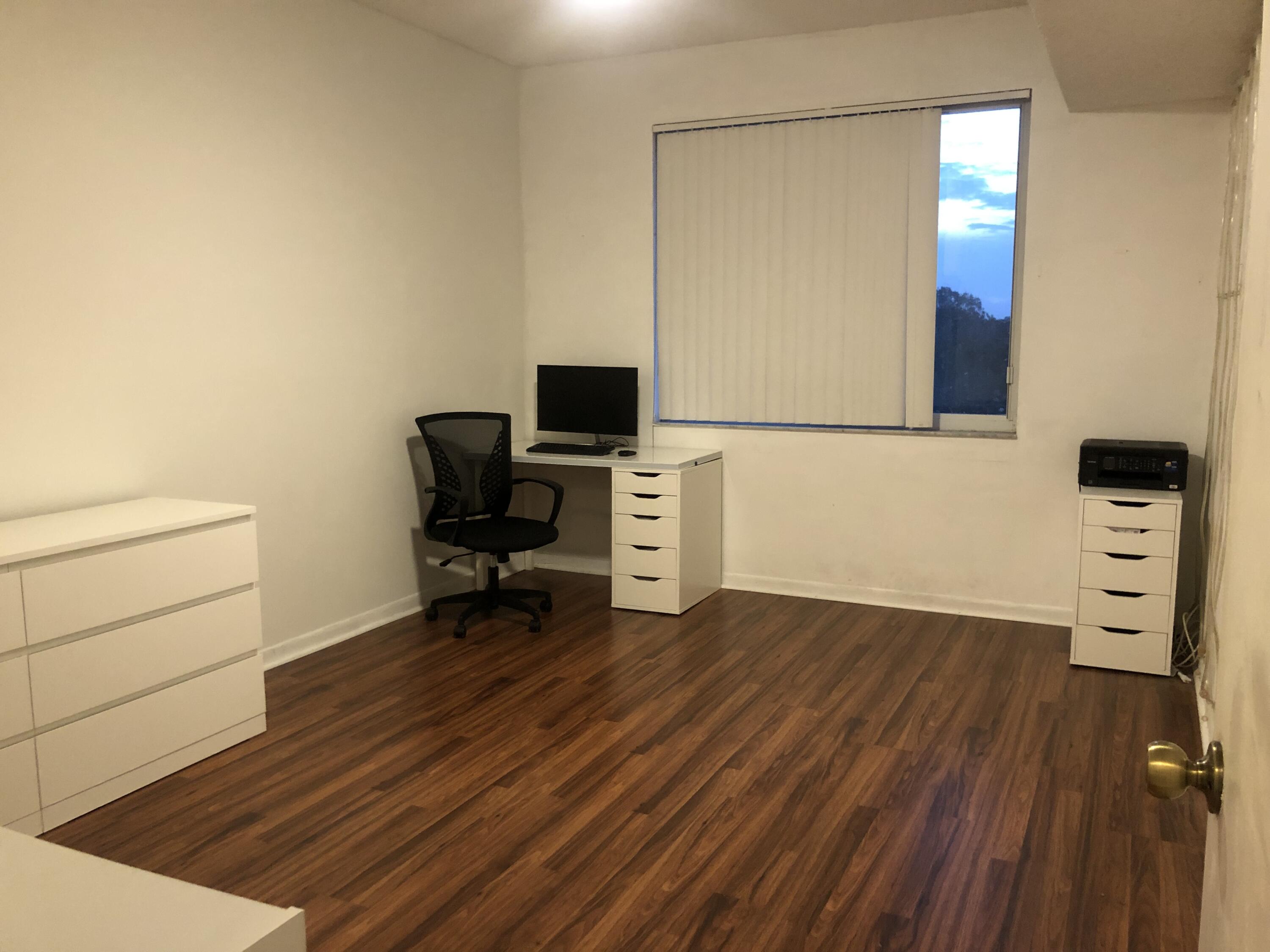 6936 Southwest 39th Street, Unit 304D Davie, FL 33314 - Photo 18 of 25 a view of a workspace with furniture and wooden floor