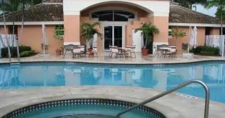 6936 Southwest 39th Street, Unit 304D Davie, FL 33314 - Photo 23 of 25 a view of a swimming pool with outdoor seating