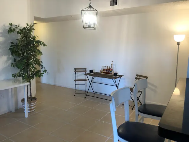 a view of a livingroom with furniture and a potted plant