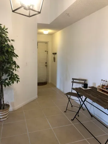a room with furniture and potted plant
