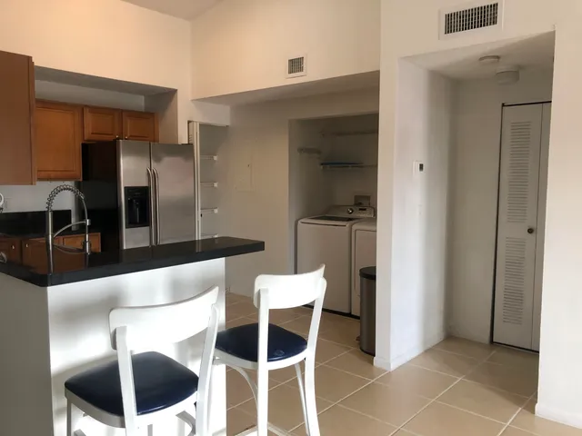 a kitchen with a table and chairs