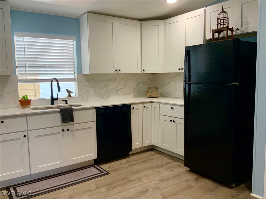 15550 Burnt Store Road, Unit 101 Punta Gorda, FL 33955 - Photo 10 of 28 a kitchen with a sink and a refrigerator