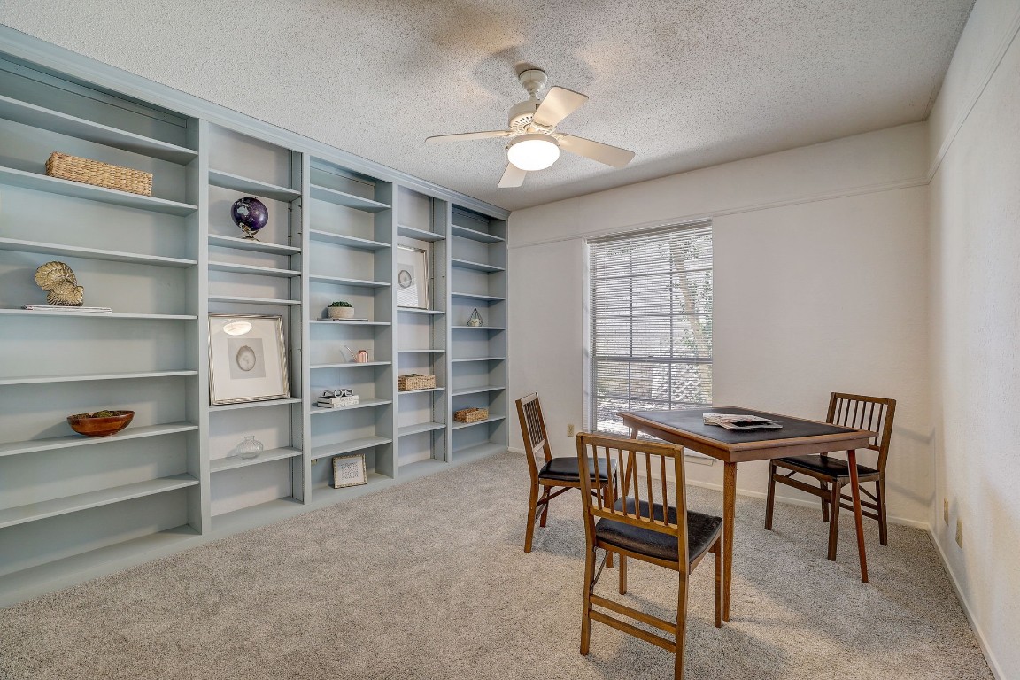 The secondary bedroom, currently utilized as an office, offers flexibility for various purposes such as another bedroom that can use this built-in shelving unit as a headboard to host all of your storage needs for knick-knacks, artwork and books, etc.  The shelving could be removed by the next homeowner as another option.