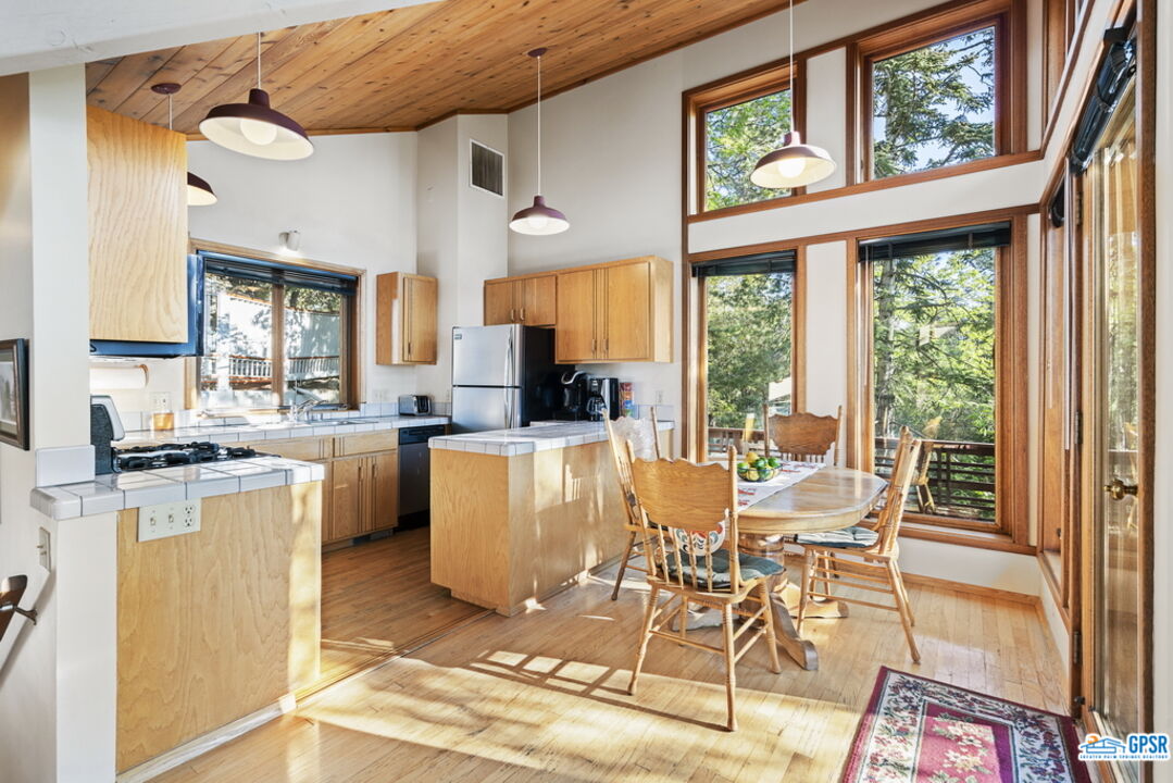 53085 Cedar Crest Drive Idyllwild, CA 92549 - Photo 12 of 55 a view of a dining room with furniture a chandelier and wooden floor
