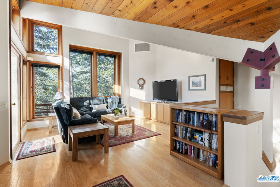 53085 Cedar Crest Drive Idyllwild, CA 92549 - Photo 2 of 55 a living room with furniture and a book shelf