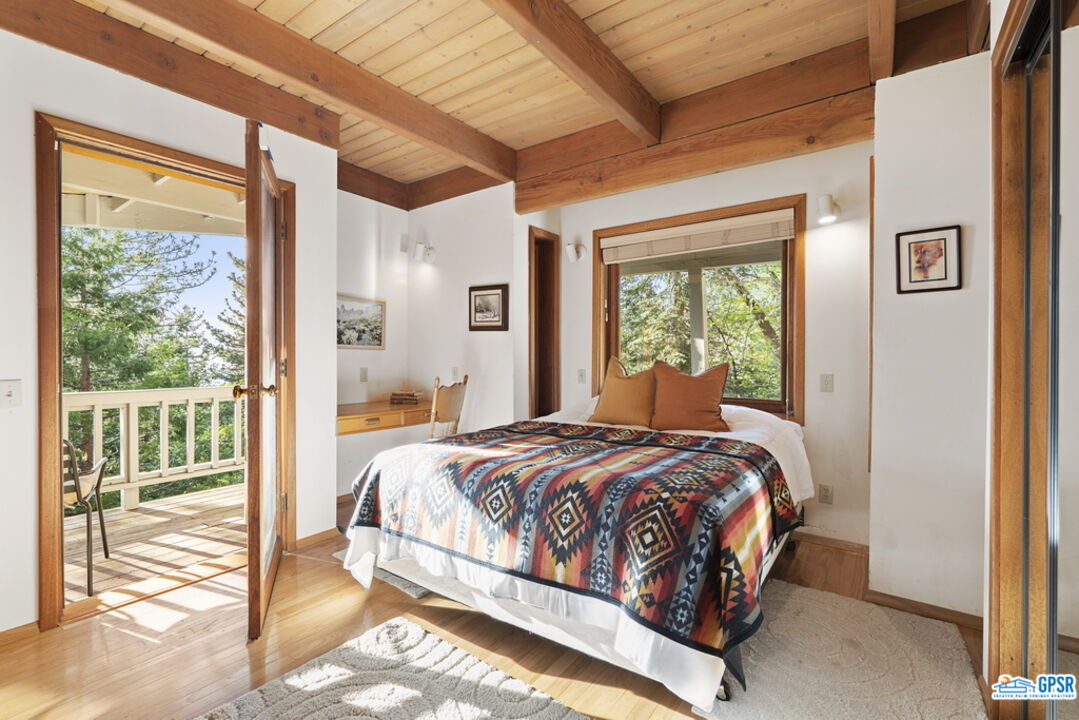 53085 Cedar Crest Drive Idyllwild, CA 92549 - Photo 28 of 55 a bedroom with a bed and glass door