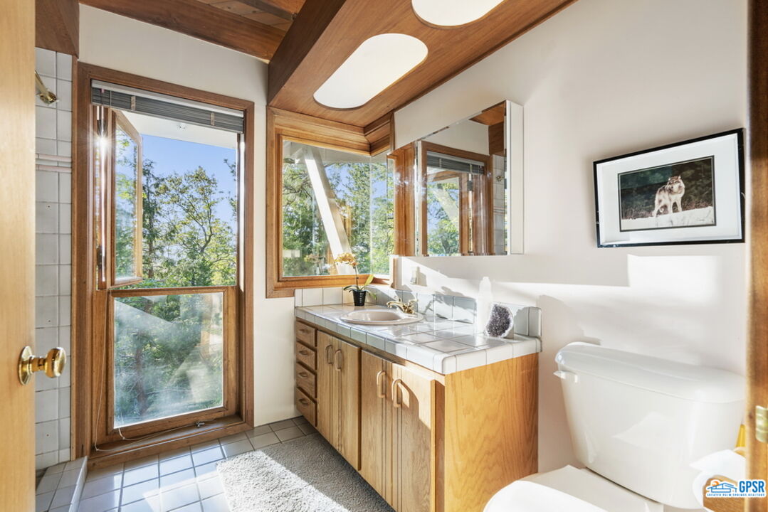 53085 Cedar Crest Drive Idyllwild, CA 92549 - Photo 31 of 55 a bathroom with a sink a mirror and a toilet