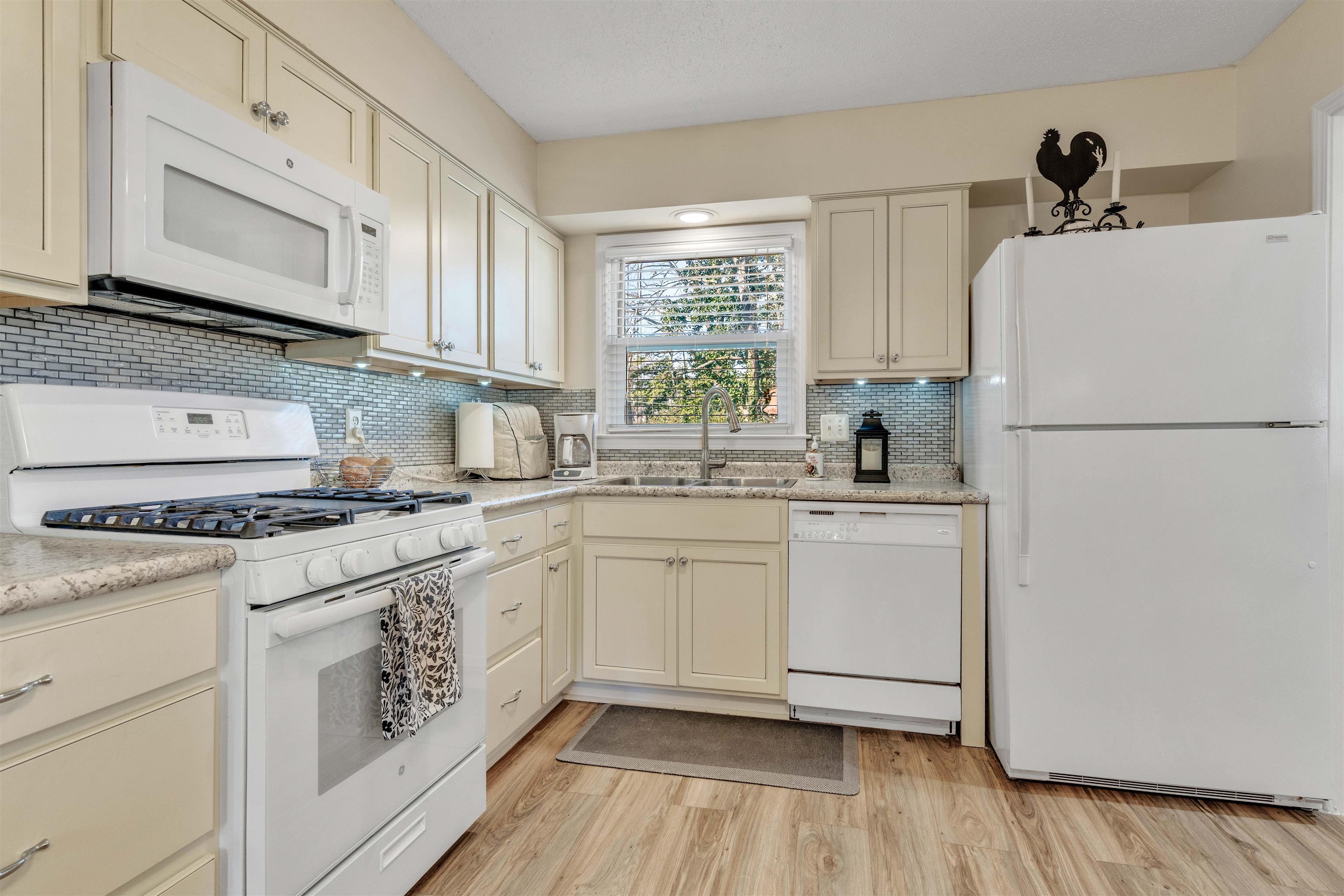 3613 Acacia Street Memphis, TN 38116 - Photo 11 of 33 a kitchen with white cabinets and white appliances