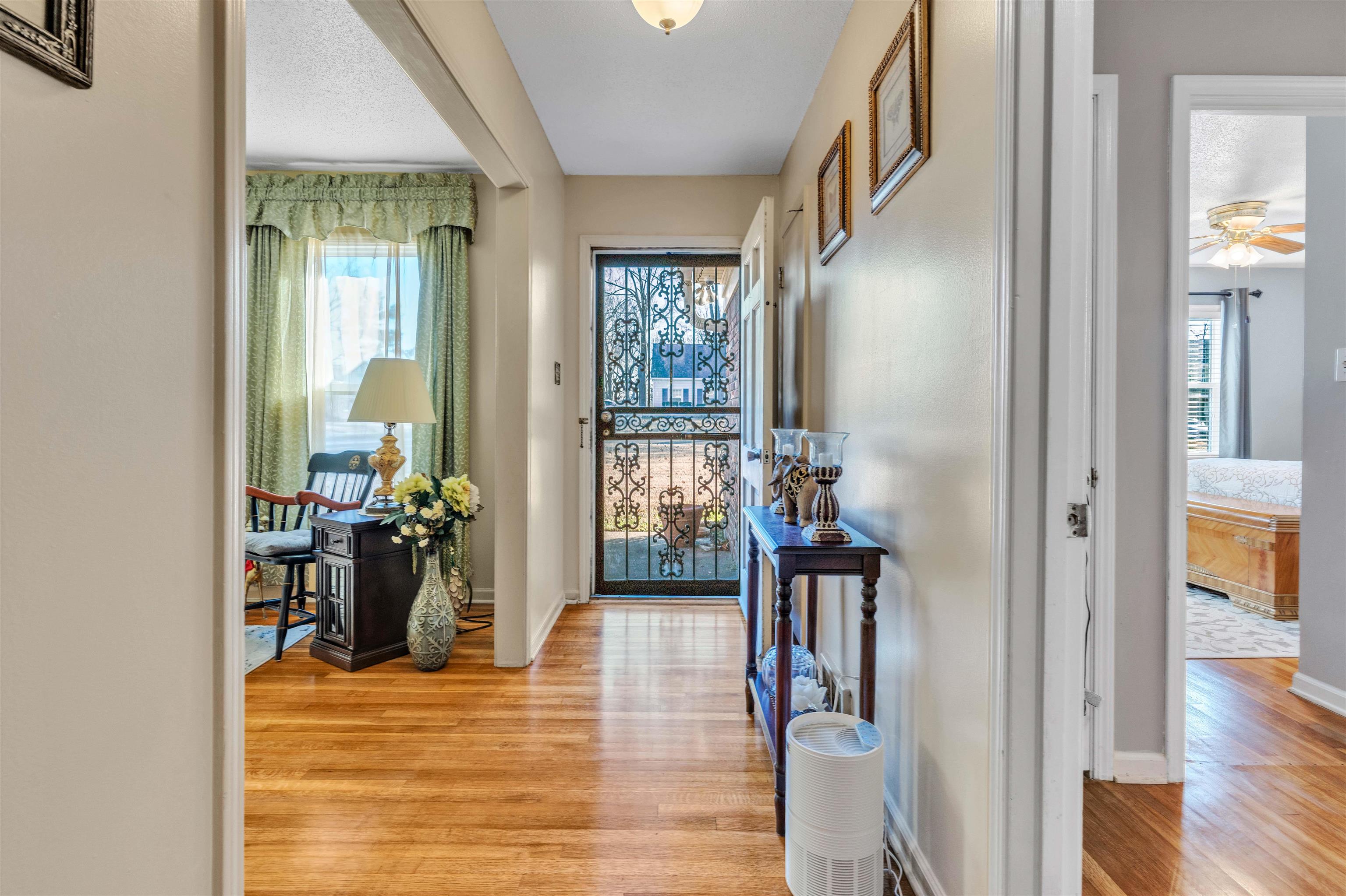 3613 Acacia Street Memphis, TN 38116 - Photo 2 of 33 a view of a hallway with wooden floor windows and livingroom
