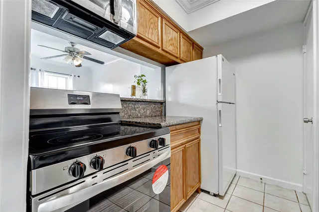 a view of kitchen stove and refrigerator