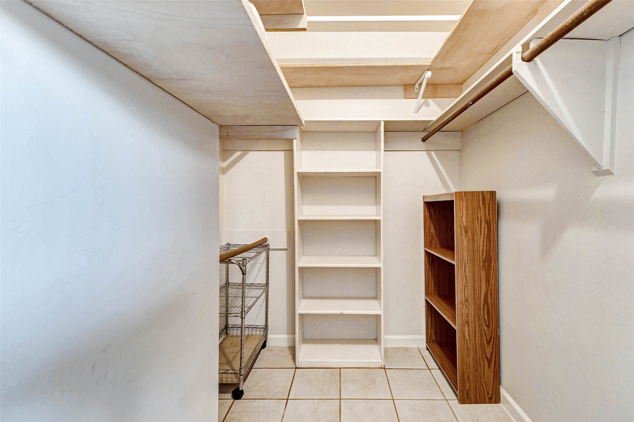 6402 Del Monte Drive, Unit 65 Houston, TX 77057 - Photo 17 of 21 a view of walk in closet with empty racks