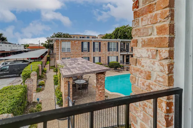 a view of a balcony with a table and chairs