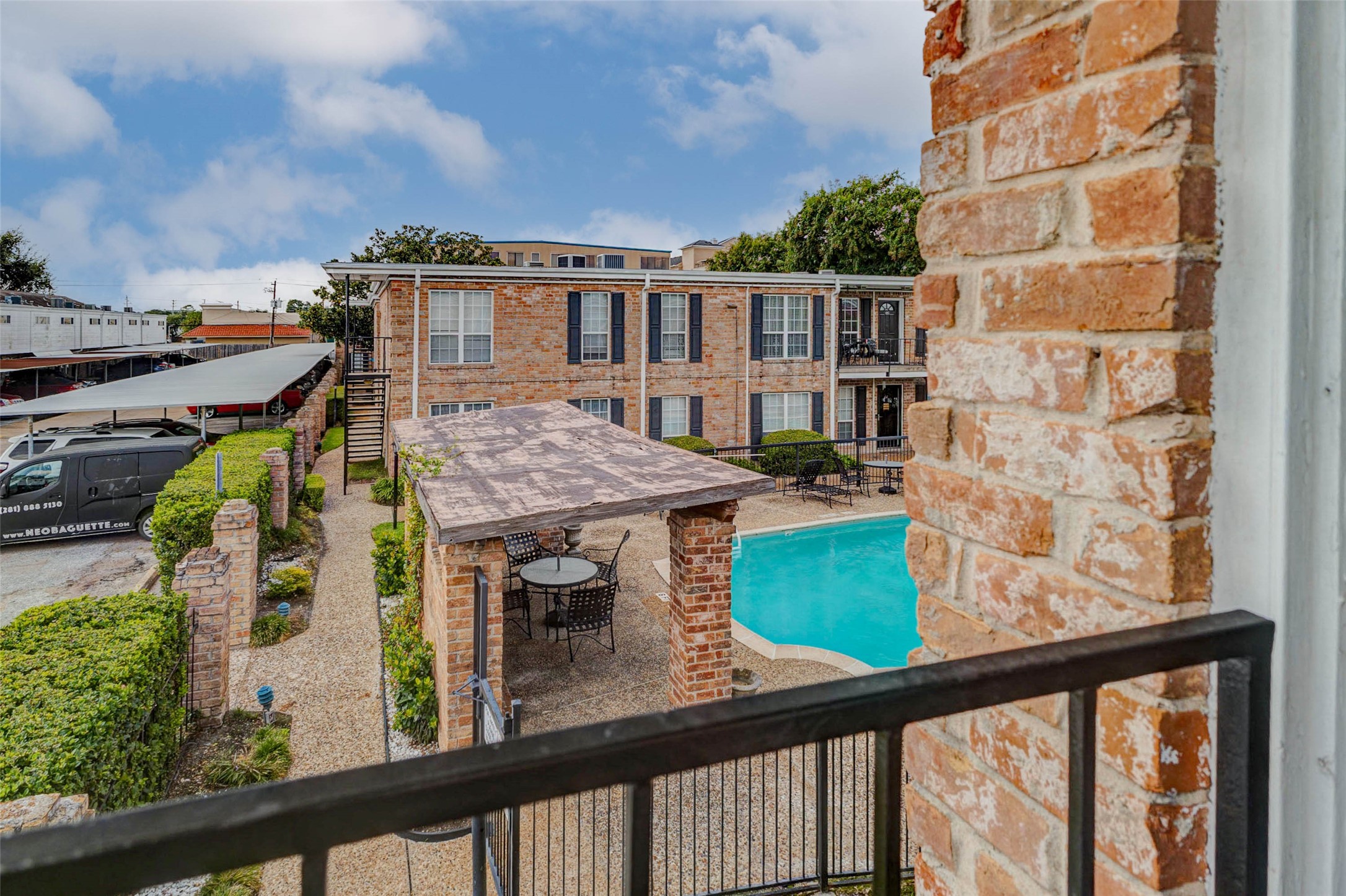 6402 Del Monte Drive, Unit 65 Houston, TX 77057 - Photo 2 of 21 a view of a balcony with a table and chairs