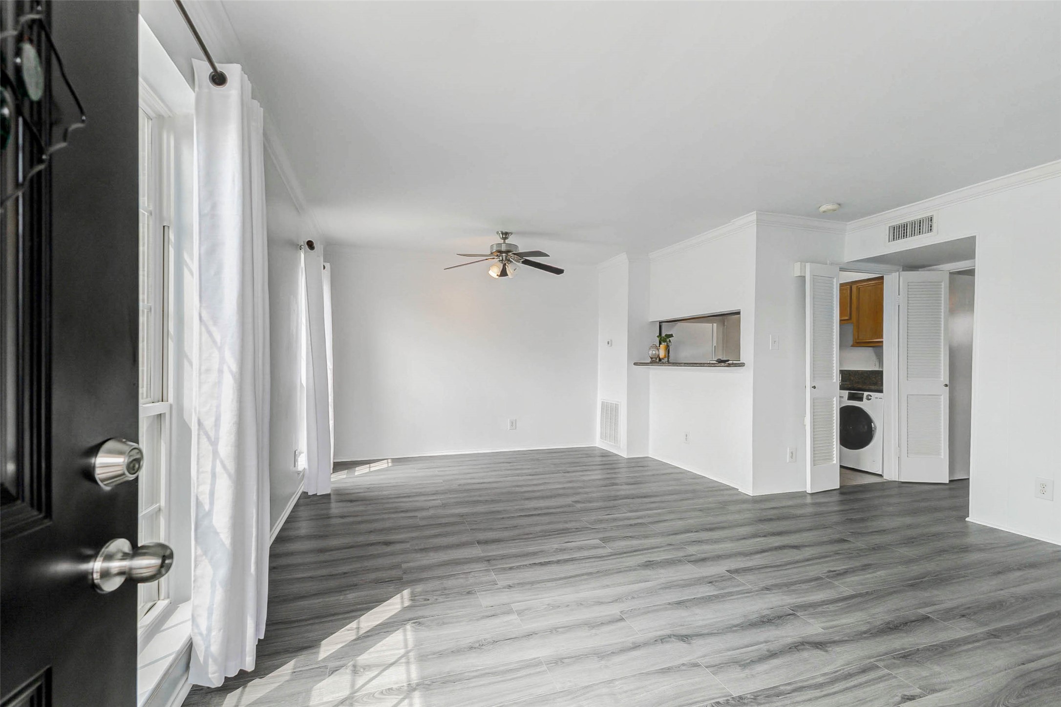 6402 Del Monte Drive, Unit 65 Houston, TX 77057 - Photo 5 of 21 a view of a hallway with wooden floor and front door